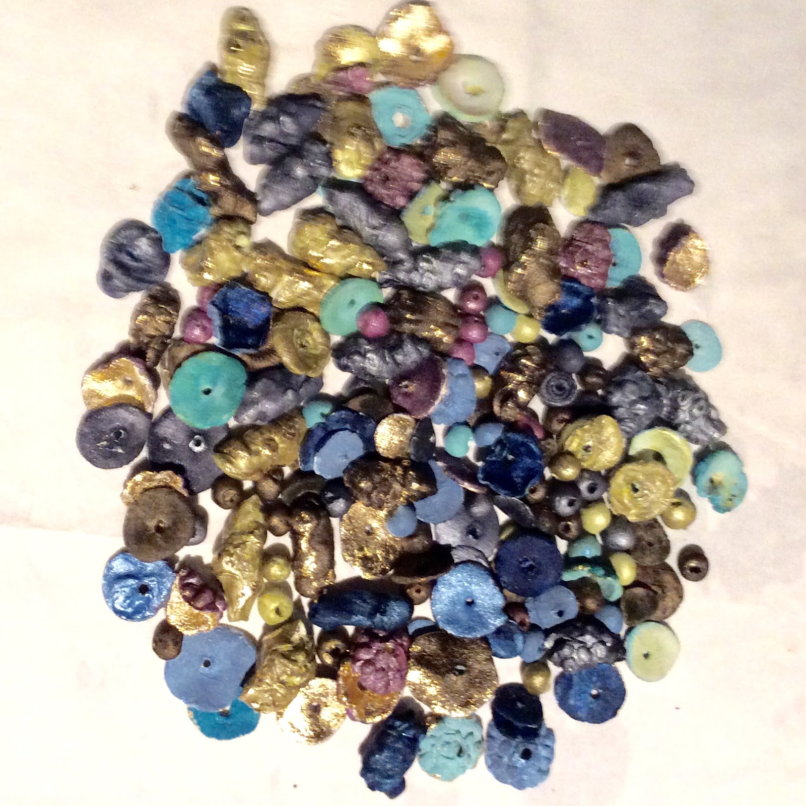 A collection of Hilary’s paper mache beads in blue, purple and gold